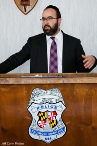 Rabbi Ariel Sadwin speaking to Baltimore police officers at the NW precinct