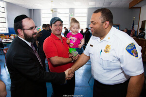 Rabbi Sadwin greeting Major Marc Partee, who is responsible for police operations for the northwest district