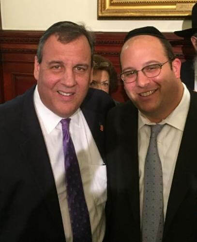  Rabbi Avi Schnall with New Jersey Governor Christie at the governor's Chanukah party 